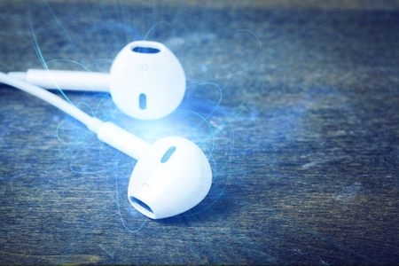 Computer headphones with laptop  on background
