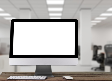 Monitor with blank screen on wooden table