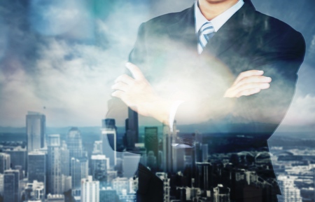 Young handsome businessman on blurred cityscape backgroundの写真素材