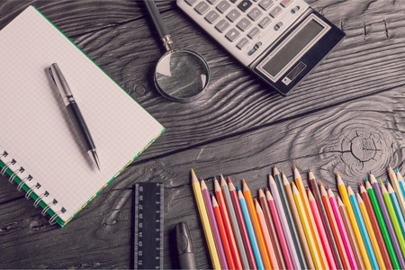 Pencils ,notebooks and phone on table