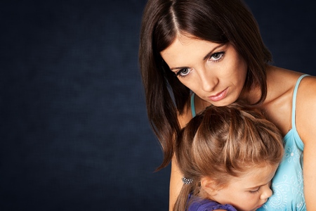 Portrait  of sad Mother with daughterの写真素材