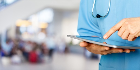 Close-up Doctor at hospital working with tablet
