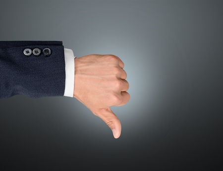 Businessman showing thumbs up over blue backgroundの写真素材