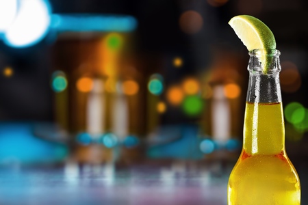 Cold beer with lime on backgroundの写真素材