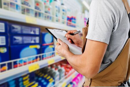 Worker writing on paperclip, close up,on backgroundのeditorial素材