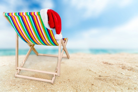 Colorful Chair with female hat on sandy beachの写真素材