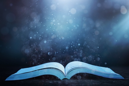 image of open antique book on wooden tableの写真素材