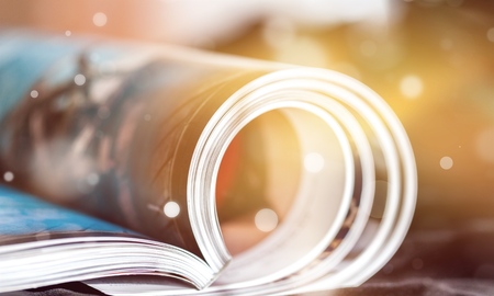 Rolled up magazines with reflection on  backgroundの写真素材