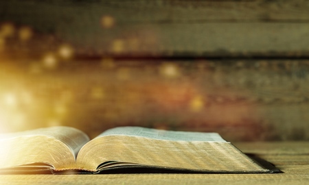 Open bible and black backgroundの写真素材