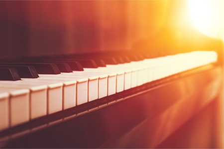 The piano was set up in the music room by the windows in the morning to allow the pianist to rehearse before the classical piano performance in celebration of the great businessman's success.の写真素材