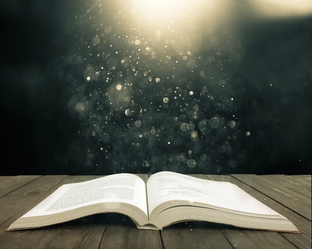Open antique book on woodenの写真素材