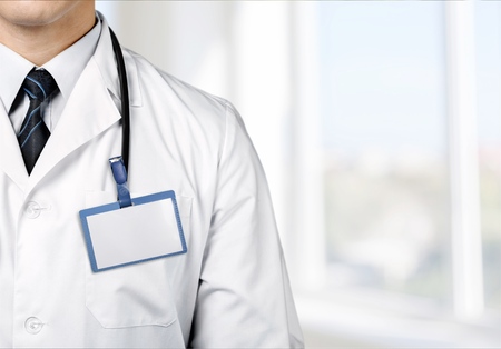 Blank badge on doctor in a white coat with a stethoscopeの写真素材