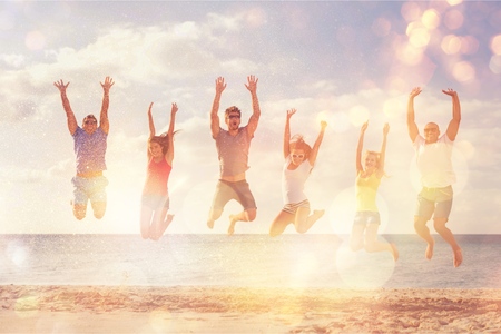 Group of happy friends having fun together on the beachの写真素材