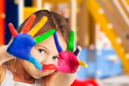 Cute little girl with painted handsの写真素材