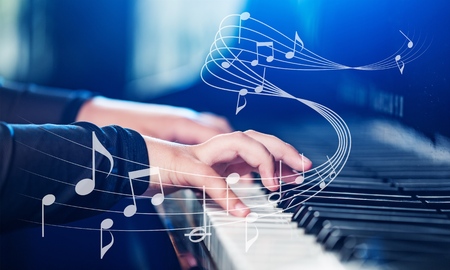 Close up of a musician playing a piano keyboard