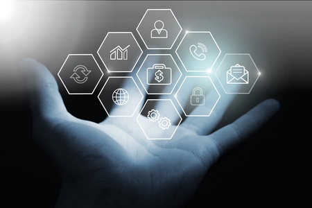 Human hand showing icons network on backgroundの写真素材