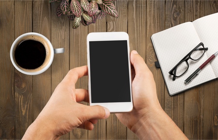 holding  phone with home screen Shortcuts app.   was created and developed by the  inc.の写真素材