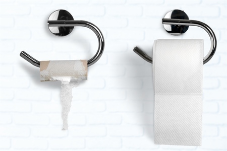 Roll of white toilet paper on metal paper holderの写真素材