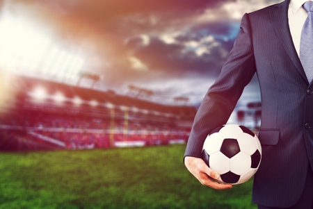 soccer manager holding football in the stadiumの写真素材