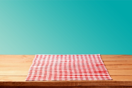 Red cloth napkin on wooden backgroundの写真素材