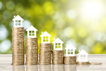 Home loan / reverse mortgage, asset refinancing concept : Small house or home on stacks of coins, depicts a homeowner or a borrower turns properties into cash, saving money to buy shelter, basic need
    
    - Imageの写真素材