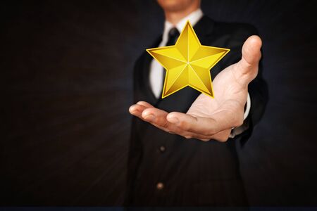 human hand holding golden starの写真素材