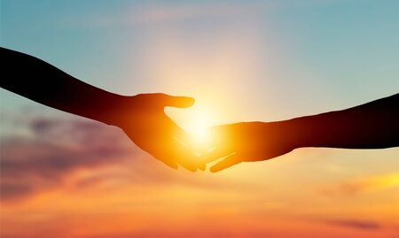 Giving a helping hand on the background of the dawn
    
    - Imageの写真素材