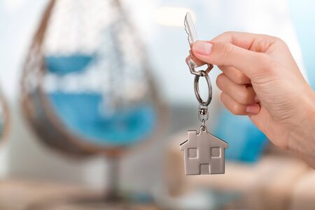 Hand holding Key to New House Inside New Construction
    
    - Image