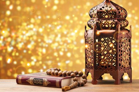 Three months.Islamic Holy Book Quran with rosary beads under soft light on white background. Ramadan concept .の写真素材