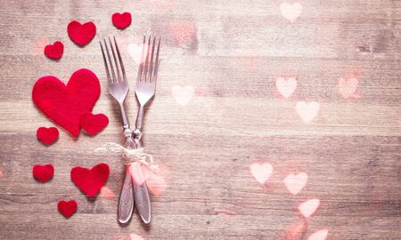 Valentines dinner romantic love food and love cooking concept - Romantic table setting decorated with fork spoon and red heart on white wooden texture background top view copy space
    
    - Imageの写真素材