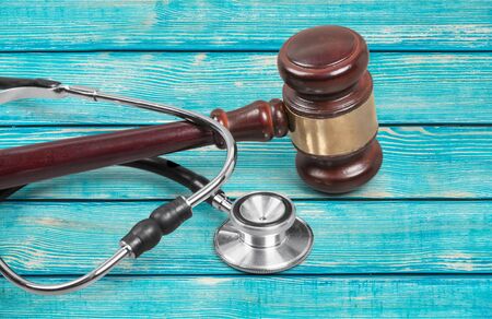 Gavel and stethoscope  on background, symbol photo for bungling and medical errorの写真素材
