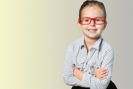 Portrait of a cute young boy with glasses isolated on  background. Studio shot.の写真素材