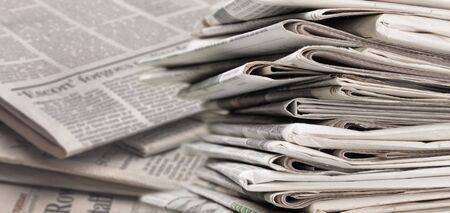 Pile of newspapers on white backgroundの写真素材