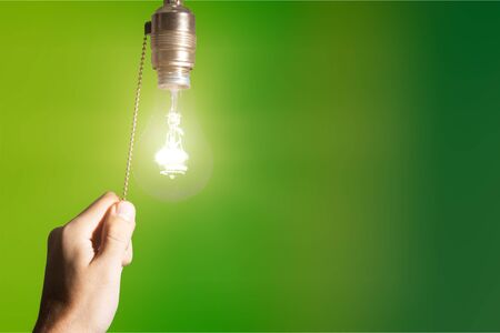 Hand turning off the bulb lamp.Turning off the light.