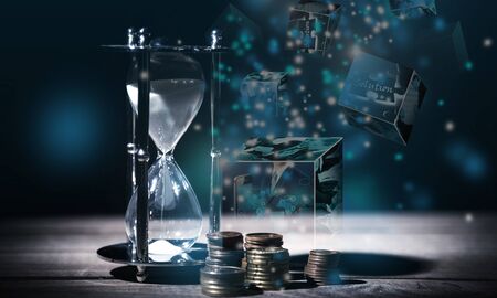 Sand running through the bulbs of an hourglass on black background with coins