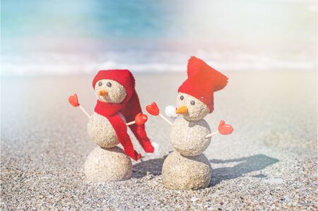 Sandy snowmen. Holiday concept can be used for New Years and Christmas Cardの写真素材