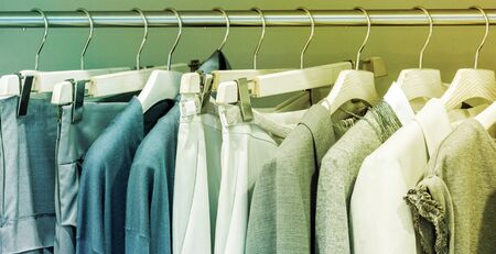 Modern clothes on metal hangers in closetの写真素材
