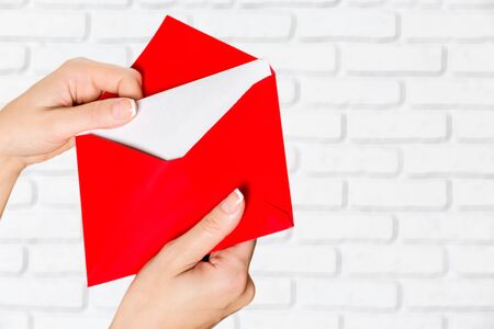 Young woman hands holding an envelope