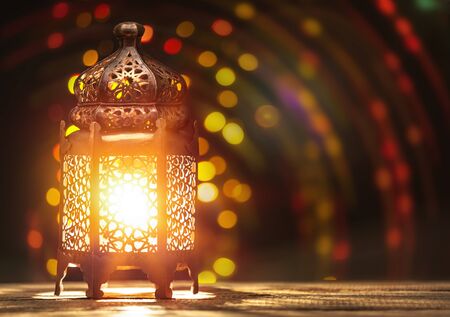 Ornamental Arabic lantern with burning candle glowingの写真素材