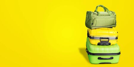 Banner Blue and Pink Trunks Summer Straw and Fabric Hats Two Suitcases Luggage Travel Things Concept Holiday Adventure Trip Isolated on Yellow Backgroundの写真素材