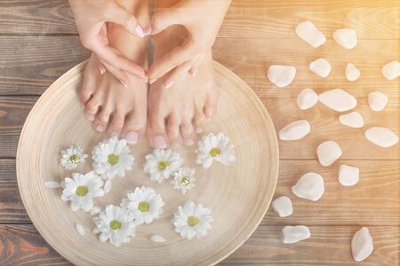 Photo of a female feet and flowerの写真素材
