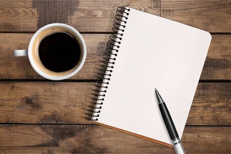 Notebook and cup of coffeeの写真素材