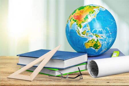 Globe, notebook stack and pencils. Schoolchild and student studies accessories. Back to school concept.の写真素材