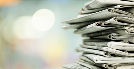 Pile of printed newspapers on backgroundの写真素材