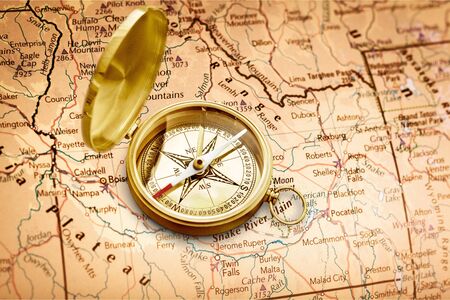 Old style brass compass on white background