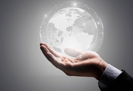 Businessman holding in hand with global connection concept.