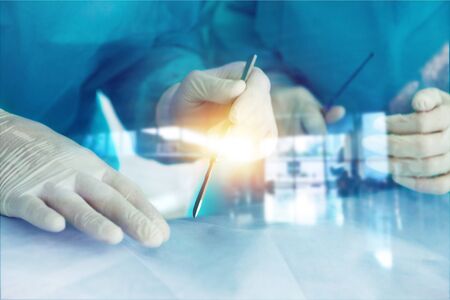 Young doctors in blue uniform doing operationの写真素材