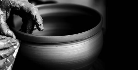 Hands of potter making clay potの写真素材