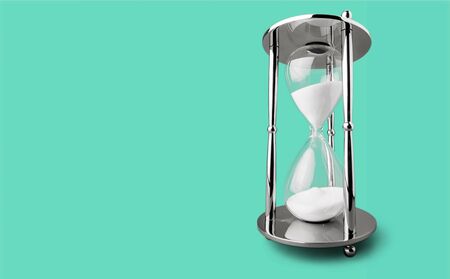 Hourglass on color background. Time management concept
    
    - Image