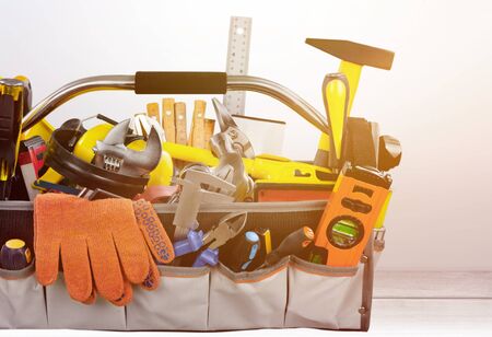 Gloves and tools on wooden background